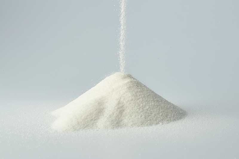 sugar falling into a pile
